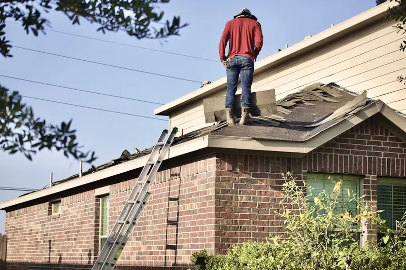 Professional roofer working on a residential roof in East Liverpool